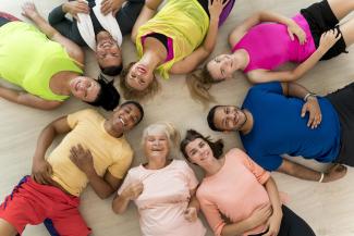 A group of sportsman lying on the ground smiling
